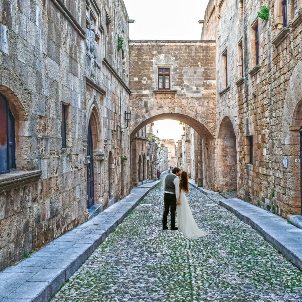 Romantic wedding ceremony in the Medieval City of Rhodes, Greece, featuring historic stone architecture, fairy-tale ambiance, and elegant floral decorations.